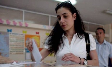 A Greek woman casts her vote at a polling station on June 17 in Athens. The Greek electorate goes to the polls in a re-run of the general election after no combination of political parties we