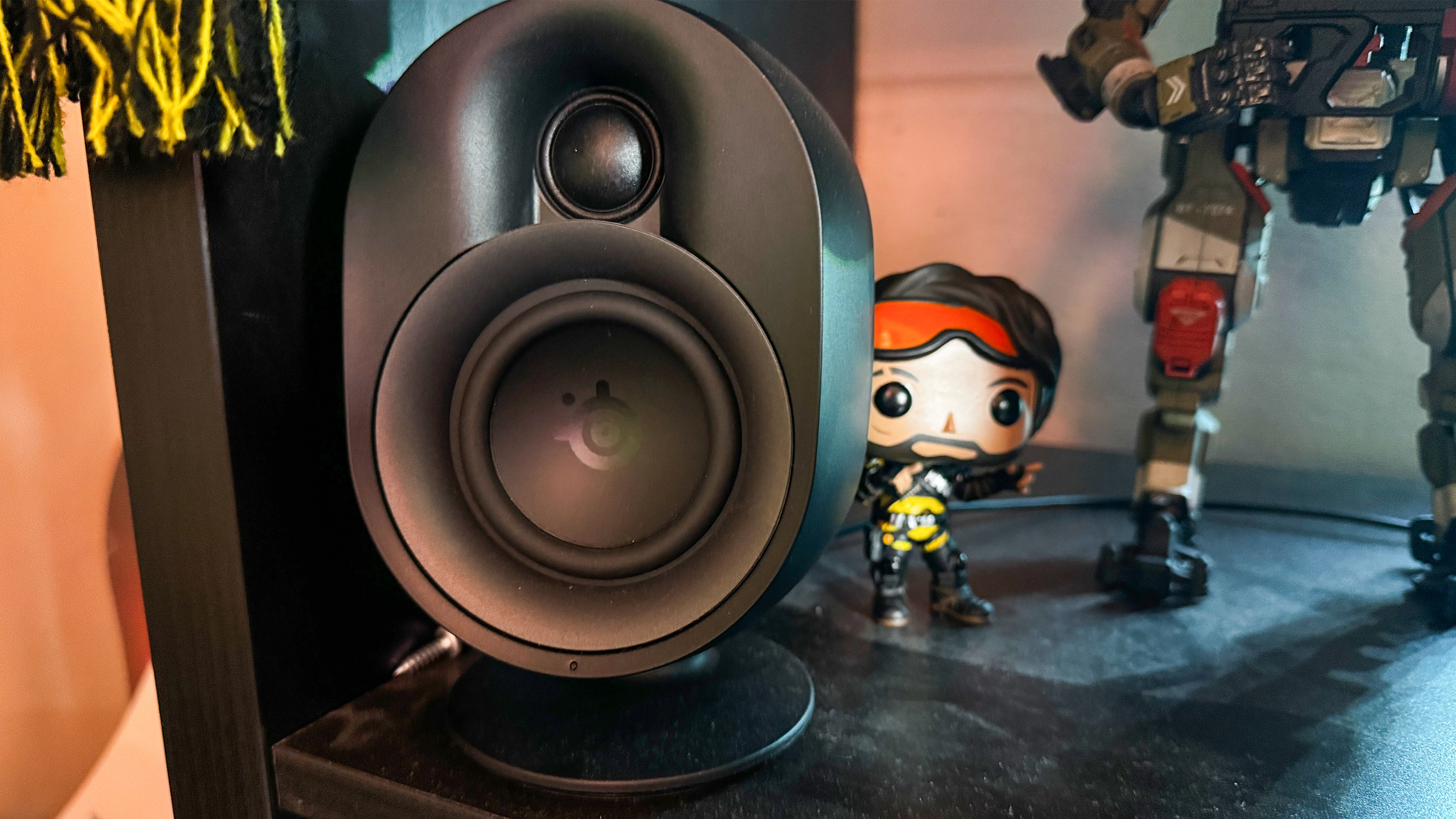 SteelSeries Arena 9 close-up on shelf with figures in the background