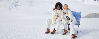 2 woman sat on chair on snow surface