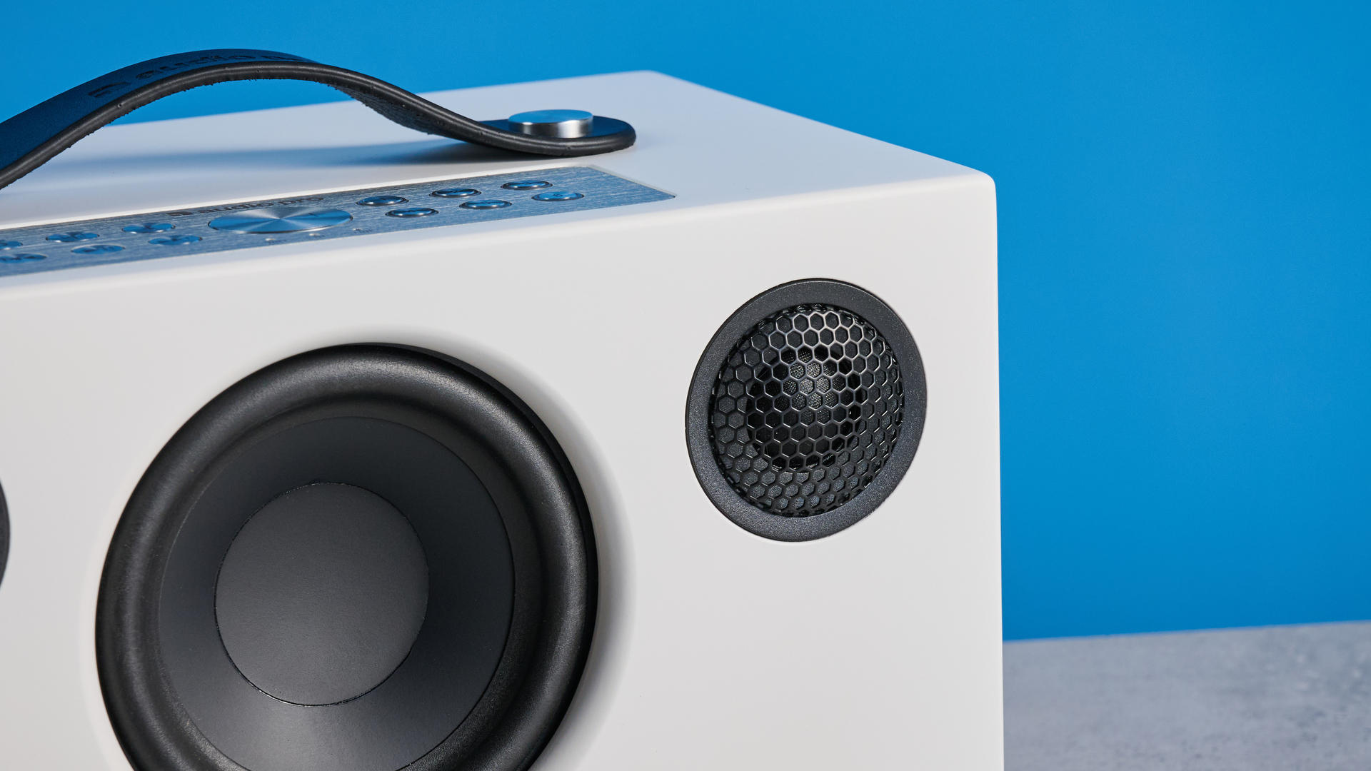 Audio Pro C5 MKII Bluetooth speaker in white photographed on a blue background
