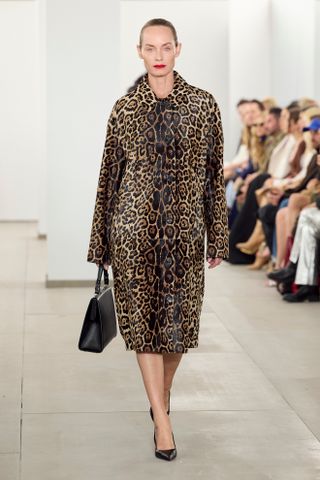 Amber Valletta wearing a leopard print calf hair coat at the Michael Kors Collection F/W 24 show.