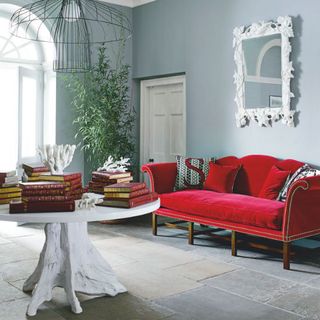 room with red sofa and white wall