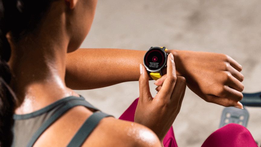 Woman checking workout stats on a TicWatch E3