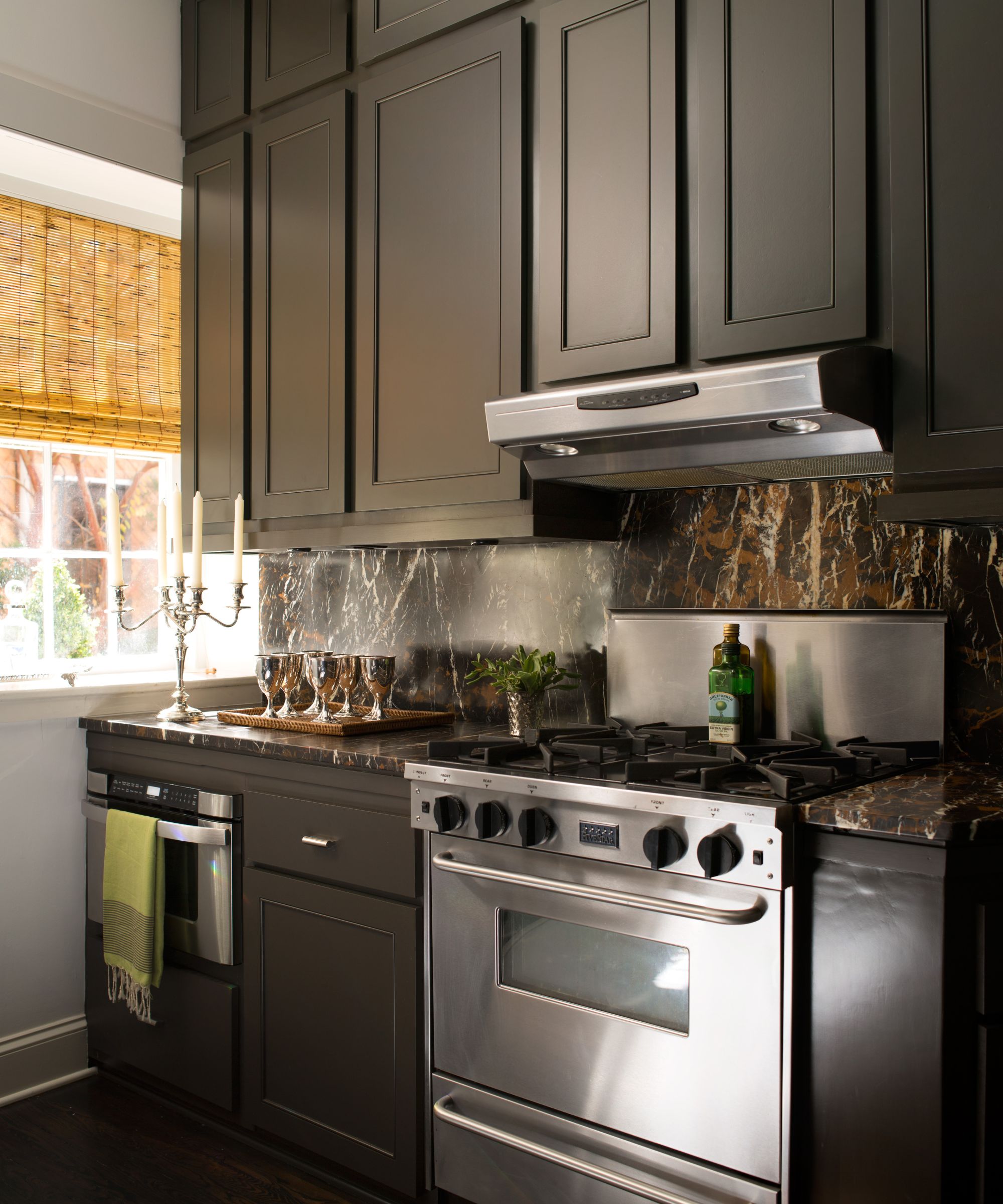 A kitchen with white walls, brown cabinets, and stainless steel appliances