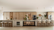 huge modern kitchen with long island with four separate sections and pendant lighting