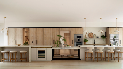 huge modern kitchen with long island with four separate sections and pendant lighting