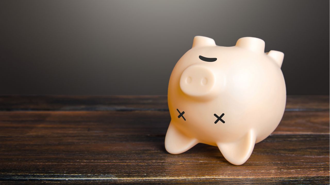 A piggy bank upside down with X&#039;s over the eyes.