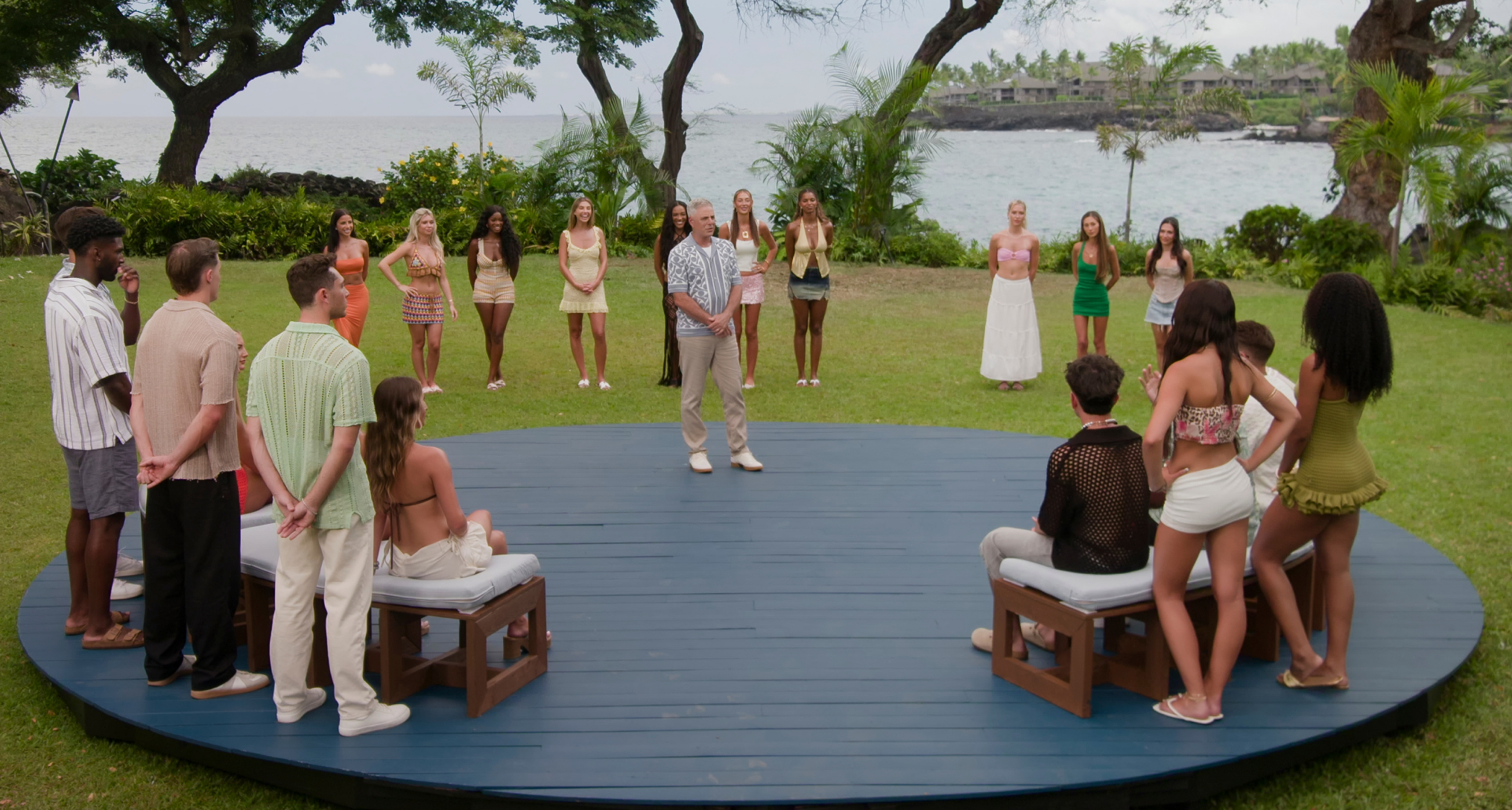 the cast of temptation island stands in a circle with the couples on one side and the tempters on the other in a season 2 still