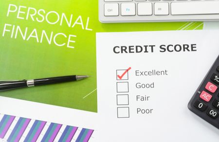 Credit Score report with tick mark. Personal finance and investment chart in the background.