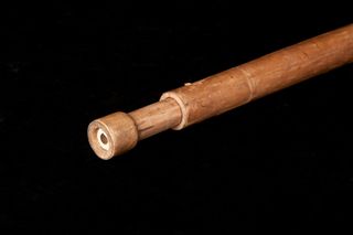 replica telescope - a long brown tube with an eyepiece at the end.