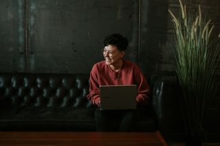 Person smiling using a laptop