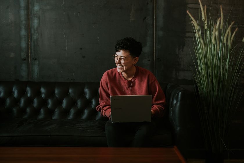 Person smiling using a laptop