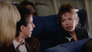 Jerry Seinfeld as Jerry Seinfeld and Debra Jo Rupp as Katie on an airplane on Seinfeld