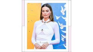 Margot Robbie wears a white, Chanel jumpsuit as she attends the Warner Bros. Premiere of "The Suicide Squad" at The Landmark Westwood on August 02, 2021 in Los Angeles, California.