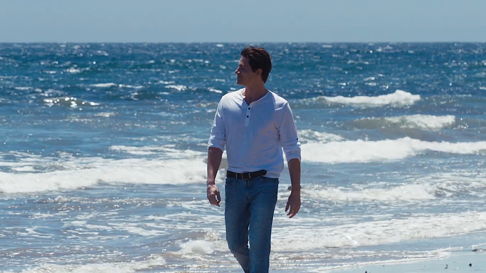 Robert Palmer Watkins as Garret Dalton is shown walking on the beach in The Final Rose.