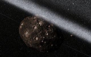 A dimly-lit, crater-ridden space rock sits large left of center. The black backdrop of space is riddled with faint stars, while a dusty white rush forms a thick, nearly solid line cutting the image diagonally from top left to below the middle of the right side.