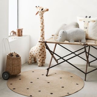 white childrens room with giant giraffe toy