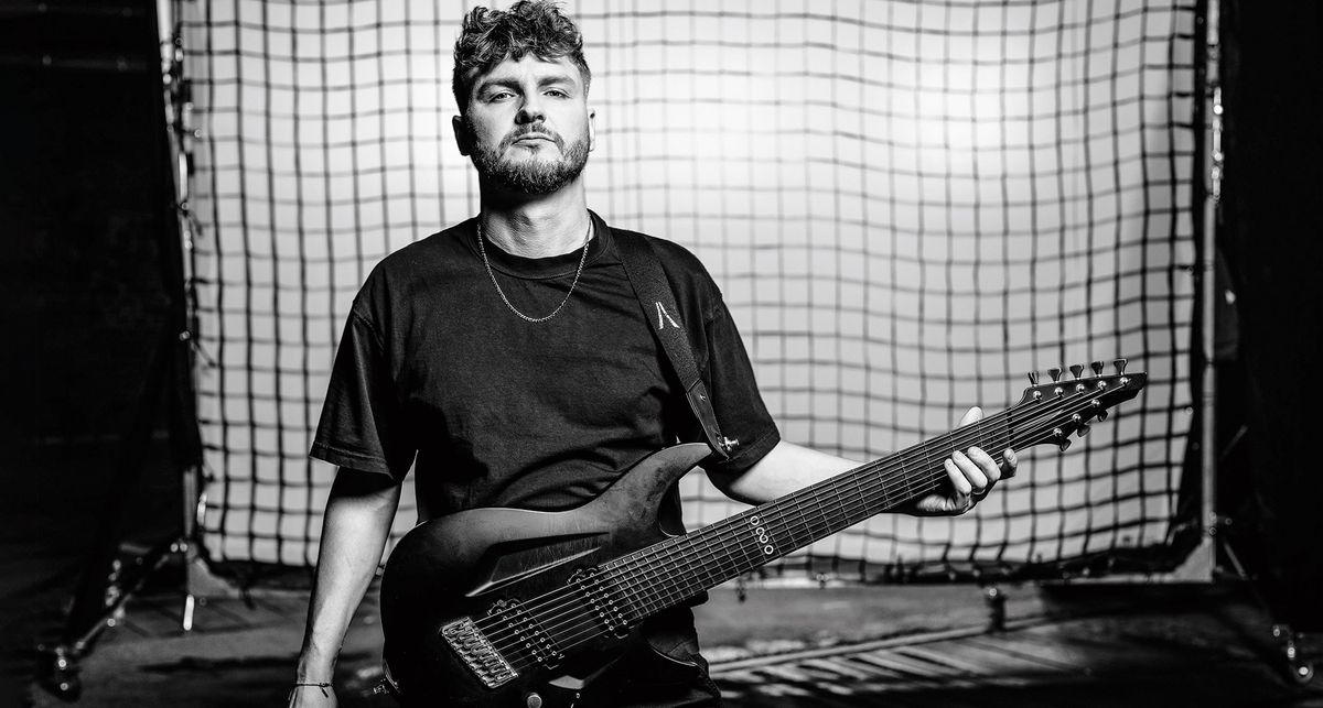 A black-and-white image of Tohr Oddman Suhrke with his custom 8-string Aristides guitar