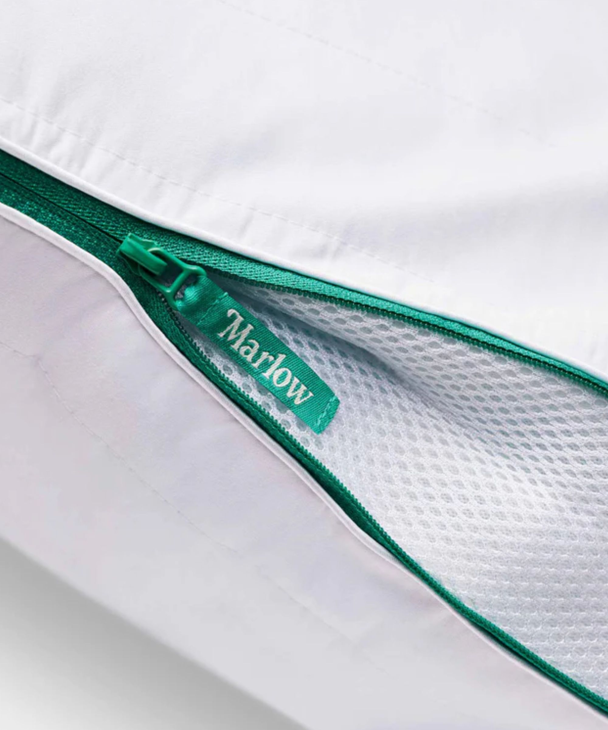 White Marlow pillow with green zippers