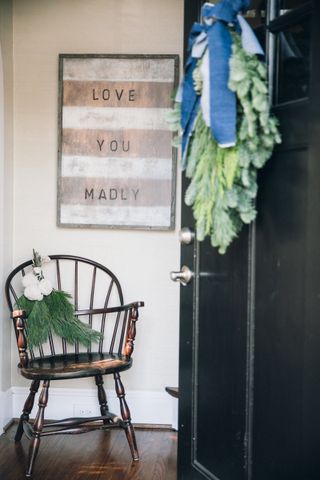 wooden chair with festive foliage in house entryway