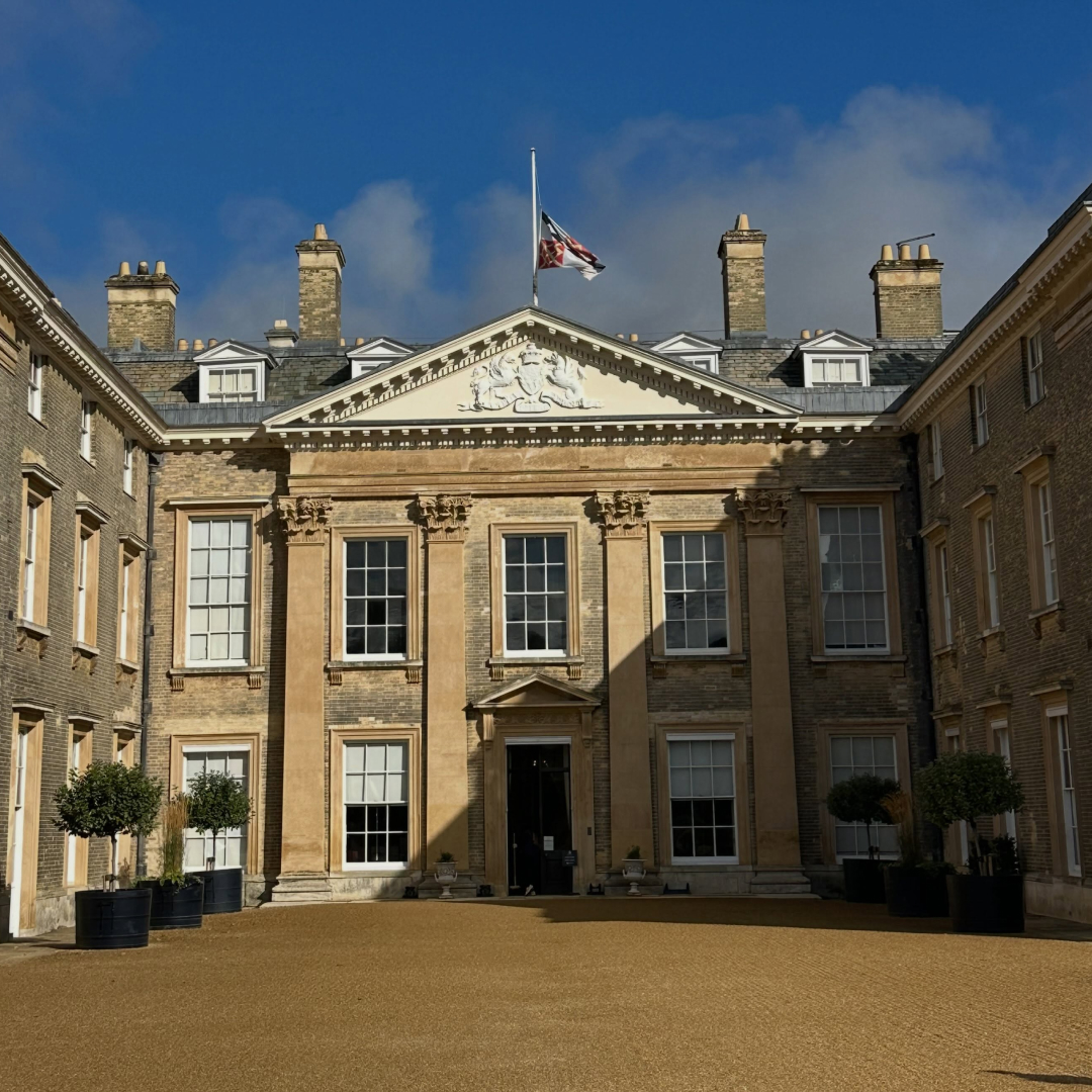 The exterior of Althorp House with a lowered flag