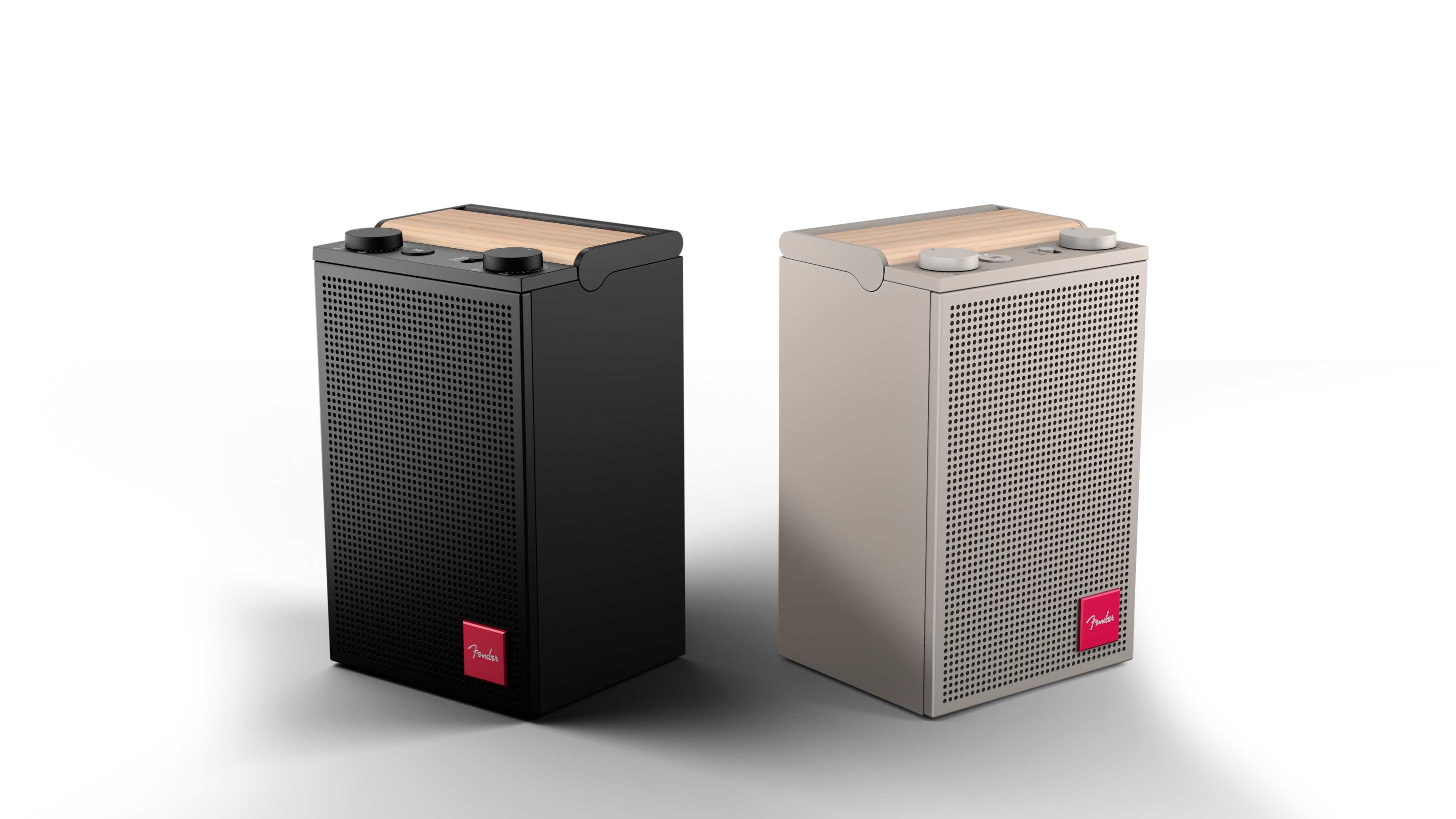 A black and a white Fender Audio ELIE speaker, facing away from each other on a white background.