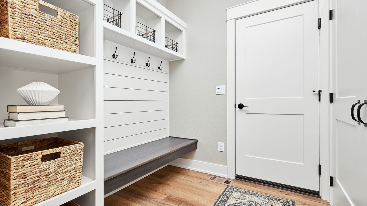 White entryway with bench