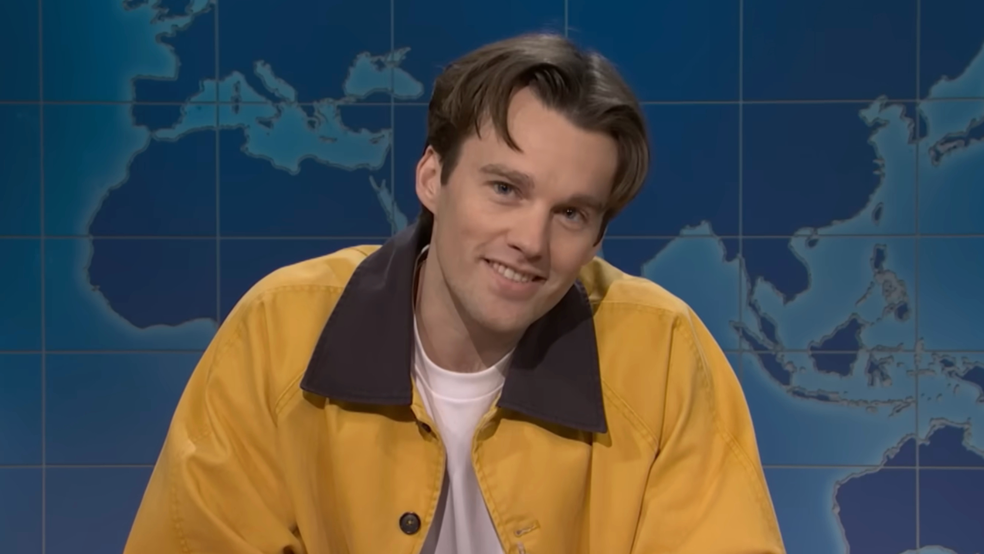 Tommy Brennan wears a yellow jacket during a Weekend Update appearance.