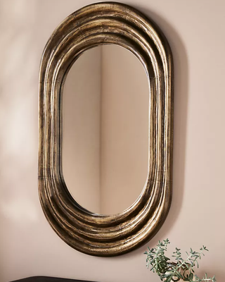 Oval antique brass statement wall mirror.
