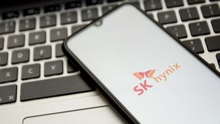 SK Hynix logo displayed on a smartphone sitting on a laptop's keyboard