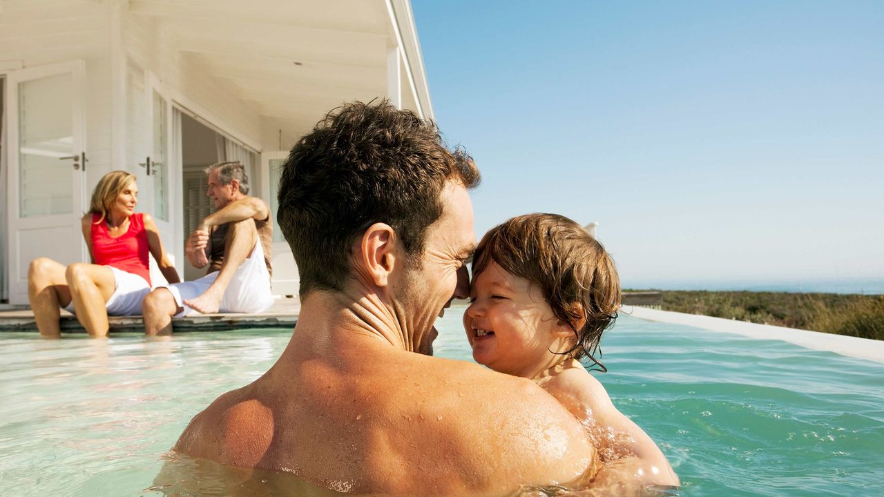 A family plays in their pool.