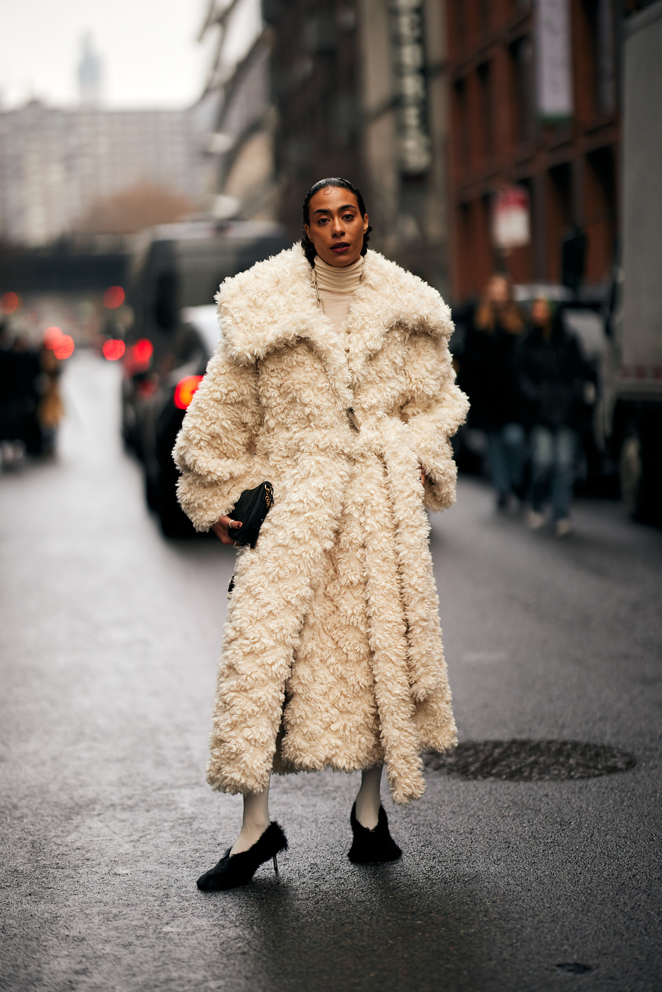 Fur accessory trend is shown in a street style photo of a woman