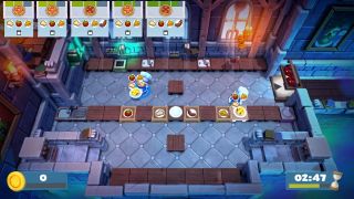 Overcooked 2 co-op - two players collaborate to construct pizzas in a castle