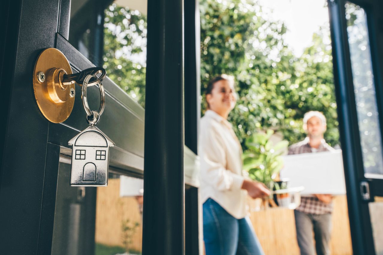 Couple celebrating moving day, mortgage, and relocation concep