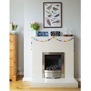 white wall white fire place and wooden flooring