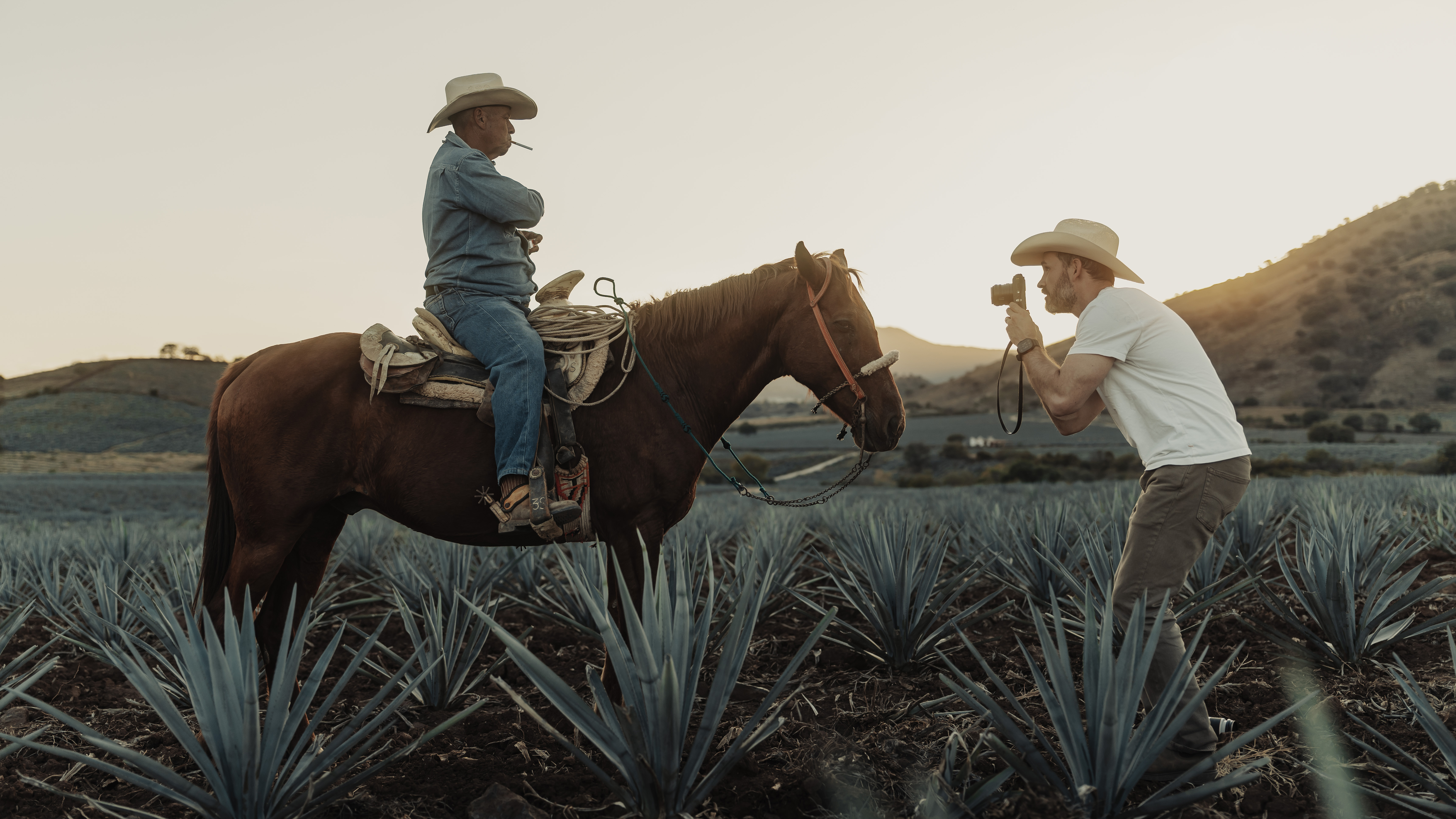 The PolarPro Goldstache filter being used by a photographer photographing a cowboy on a horse