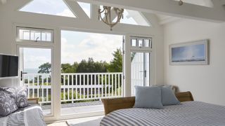 white bedroom with upvc patio doors towards balcony
