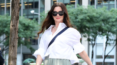Anne Hathaway wearing a pleated skirt