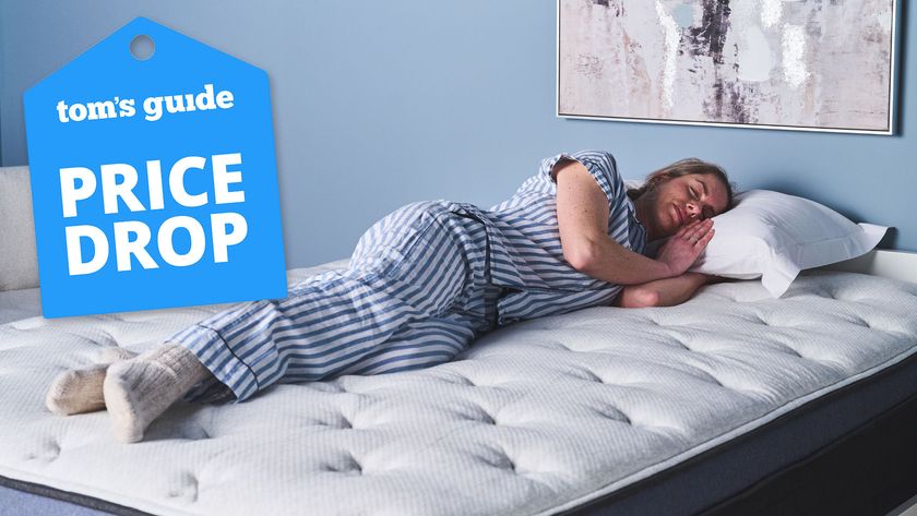 A woman lying on her side on the Helix Midnight Luxe mattress, a Tom&#039;s Guide price drop deals graphic