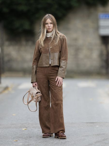 woman wearing head to toe brown suede with a jacket and pants