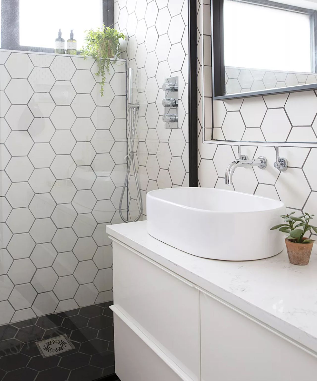 White tiled bathroom with frameless shower