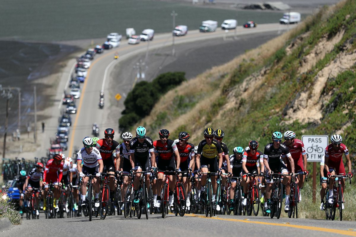 The peloton is spread across the road