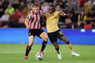 Alfie Gilchrist of Sheffield United battles for possession with Sebastian Revan of Wrexham during the Carabao Cup First Round match between Sheffield United and Wrexham at Bramall Lane on August 13, 2024 in Sheffield, England.