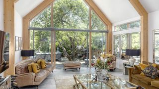 A living room of a self build home with large glass doors