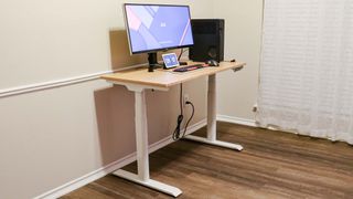 A standing desk with all of the cables neatly organized