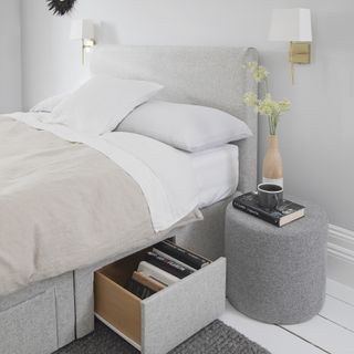 bed in grey bedroom with storage drawer