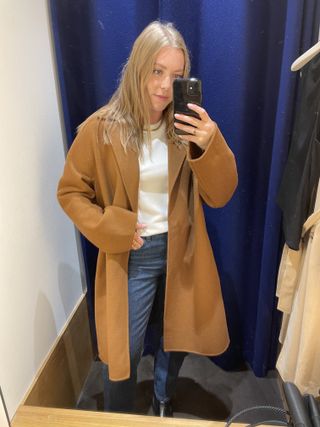 Woman wears camel coat from Whistles