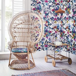 floral wallpaper with peacock chair and vintage drinks trolley