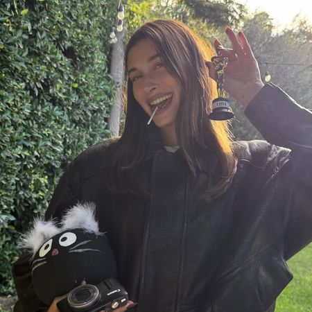 Hailey Bieber wears Gap jeans and a Saint Laurent bomber jacket at Bella Hadid's birthday party