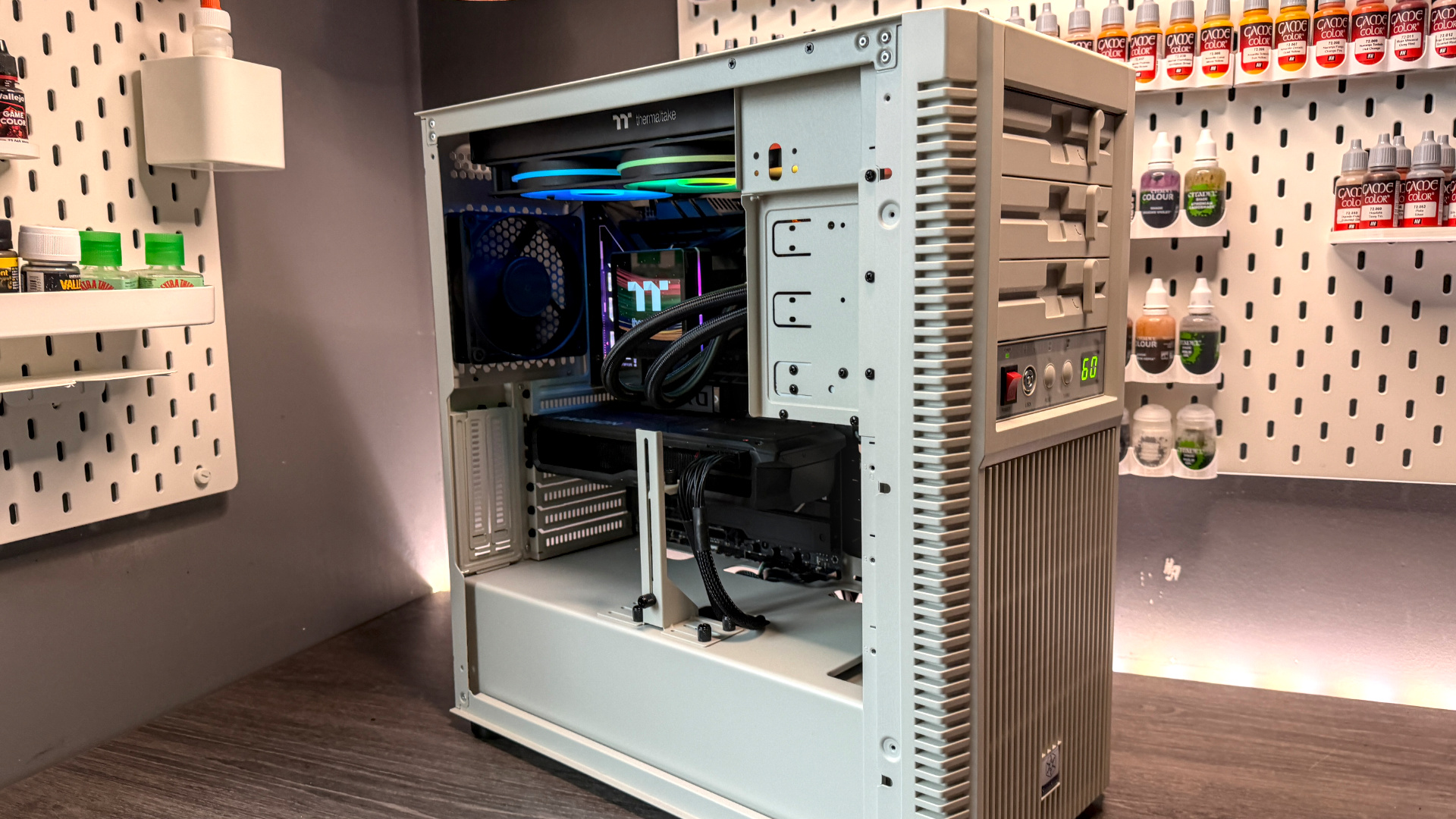 The retro-styled Silverstone FLP02 PC case as a PC is being built into it on a desk.